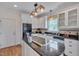 Stylish kitchen with white cabinetry, black appliances, and center cooking island at 303 Crooked Meadow Ln, Hillsborough, NC 27278