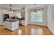 Bright kitchen featuring a center island, stainless steel appliances, and custom cabinets at 303 Crooked Meadow Ln, Hillsborough, NC 27278