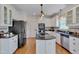Updated kitchen with white cabinets, dark countertops, and stainless steel appliances at 303 Crooked Meadow Ln, Hillsborough, NC 27278