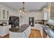 Modern kitchen featuring a central island with a stovetop and open cabinets at 303 Crooked Meadow Ln, Hillsborough, NC 27278