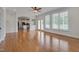 Open living room with gleaming hardwood floors flowing into kitchen space at 303 Crooked Meadow Ln, Hillsborough, NC 27278