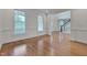 Living room with hardwood floors and view into the entry foyer and front porch at 303 Crooked Meadow Ln, Hillsborough, NC 27278