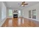 Cozy living room showcasing a fireplace, hardwood floors, and a ceiling fan at 303 Crooked Meadow Ln, Hillsborough, NC 27278