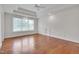 Spacious main bedroom with tray ceiling, hardwood floors, and large windows offering abundant natural light at 303 Crooked Meadow Ln, Hillsborough, NC 27278