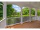 Covered porch view of green lawn with mature trees and landscaping at 303 Crooked Meadow Ln, Hillsborough, NC 27278