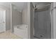 This bathroom features a tub and stand up shower with glass doors at 3069 Buttonwood Ln, Clayton, NC 27520
