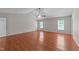 This bedroom features hardwood floors, a ceiling fan, and two large windows at 3069 Buttonwood Ln, Clayton, NC 27520