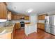 Well-lit kitchen featuring granite countertops, stainless steel appliances, and a central island at 3069 Buttonwood Ln, Clayton, NC 27520