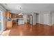 Open concept kitchen features stainless steel appliances, center island and hardwood floors at 3069 Buttonwood Ln, Clayton, NC 27520
