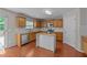 Well-lit kitchen featuring granite countertops, stainless steel appliances, and a central island at 3069 Buttonwood Ln, Clayton, NC 27520