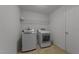 This laundry room features a washer and dryer with wire shelving at 3069 Buttonwood Ln, Clayton, NC 27520