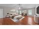 This bedroom features hardwood floors, a ceiling fan, large windows, and a queen sized bed at 3069 Buttonwood Ln, Clayton, NC 27520