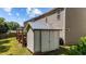 Backyard storage shed adjacent to the house with gray siding and a gabled roof at 3069 Buttonwood Ln, Clayton, NC 27520