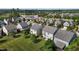 Neighborhood aerial view showcasing home with expansive lawns and mature trees in a suburban setting at 309 Windy Peak Loop, Cary, NC 27519