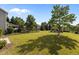 Lush backyard with mature trees, a black fence, and a gazebo in a serene setting at 309 Windy Peak Loop, Cary, NC 27519