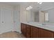 Bathroom features a double sink vanity, large mirror, and neutral tile flooring at 309 Windy Peak Loop, Cary, NC 27519