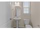 Cozy bathroom with a pedestal sink, an octagonal mirror, and a toilet at 309 Windy Peak Loop, Cary, NC 27519