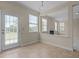 Bright dining area featuring a glass door with blinds and access to an adjacent living space at 309 Windy Peak Loop, Cary, NC 27519