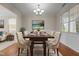 Elegant dining room with chandelier, large window, and sophisticated table setting at 309 Windy Peak Loop, Cary, NC 27519
