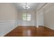 Formal dining room with hardwood floors, wainscoting, and a chandelier at 309 Windy Peak Loop, Cary, NC 27519