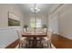 Elegant dining room with a rug, table with chairs, wainscoting, and chandelier at 309 Windy Peak Loop, Cary, NC 27519