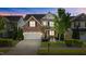Charming home showcasing manicured lawn, brick accents, and a two-car garage at 309 Windy Peak Loop, Cary, NC 27519