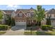 Charming home showcasing manicured lawn, brick accents, and a two-car garage at 309 Windy Peak Loop, Cary, NC 27519