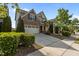 Desirable home featuring lush landscaping, brick accents, and an attached garage at 309 Windy Peak Loop, Cary, NC 27519