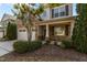 Charming home with stone accents, a covered front porch, and a well-manicured lawn at 309 Windy Peak Loop, Cary, NC 27519
