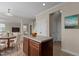 Open-concept kitchen area featuring a wood table, kitchen island, and tile flooring at 309 Windy Peak Loop, Cary, NC 27519