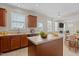 Well-lit kitchen with island, countertops, modern appliances and view to a living area at 309 Windy Peak Loop, Cary, NC 27519