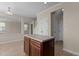 Cozy kitchen area featuring a kitchen island, tile flooring, and neutral wall colors at 309 Windy Peak Loop, Cary, NC 27519