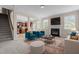 Stylish living room with fireplace, plush seating, and decorative rug creating a cozy ambiance at 309 Windy Peak Loop, Cary, NC 27519