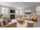 Bright living room with a fireplace, comfortable seating, and large windows offering ample light at 309 Windy Peak Loop, Cary, NC 27519