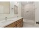 Bathroom featuring a double sink vanity and a tiled shower-tub combo at 310 W Club Blvd, Durham, NC 27704