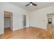 Bright bedroom featuring hardwood floors, a modern ceiling fan, and access to a walk-in closet and bathroom at 310 W Club Blvd, Durham, NC 27704