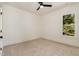 Empty bedroom with neutral carpeting and a window overlooking foliage and a blue sky at 310 W Club Blvd, Durham, NC 27704