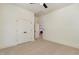 Neutral carpeted bedroom with a ceiling fan, a closet with double doors, and an entrance to another room at 310 W Club Blvd, Durham, NC 27704