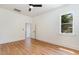 Bedroom with hardwood flooring and a doorway, window with a view of the sky and greenery at 310 W Club Blvd, Durham, NC 27704