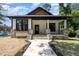 Inviting home with a stone walkway, porch with stone accents, and manicured lawn at 310 W Club Blvd, Durham, NC 27704