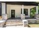 Charming front porch with stone accents, dark door, and stylish columns at 310 W Club Blvd, Durham, NC 27704