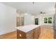A wide shot of the Kitchen, showing pendant lighting over the island and stainless steel appliances at 310 W Club Blvd, Durham, NC 27704