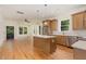 Bright open-concept kitchen featuring hardwood floors, an island, and stainless steel appliances at 310 W Club Blvd, Durham, NC 27704