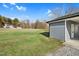Large, open backyard on a sunny day with mature trees at 311 Nc 56, Louisburg, NC 27549