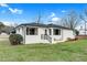 Charming single-story home featuring a brick exterior, black trim, and a well-maintained front lawn under a blue sky at 311 Nc 56, Louisburg, NC 27549