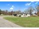 Charming one-story home with white siding, attached garage, and a spacious green lawn at 311 Nc 56, Louisburg, NC 27549