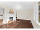 Spacious living room with hardwood floors, bright natural light, neutral paint, and a charming fireplace at 311 Nc 56, Louisburg, NC 27549