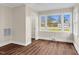 Bright sun room featuring wood paneling, crisp white trim and two large windows for ample natural light at 311 Nc 56, Louisburg, NC 27549