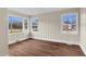 Bright sun room featuring wood paneling, crisp white trim and three large windows for ample natural light at 311 Nc 56, Louisburg, NC 27549