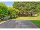 Large backyard with patio, green grass, and mature trees at 3315 Swinford Ct, Raleigh, NC 27604